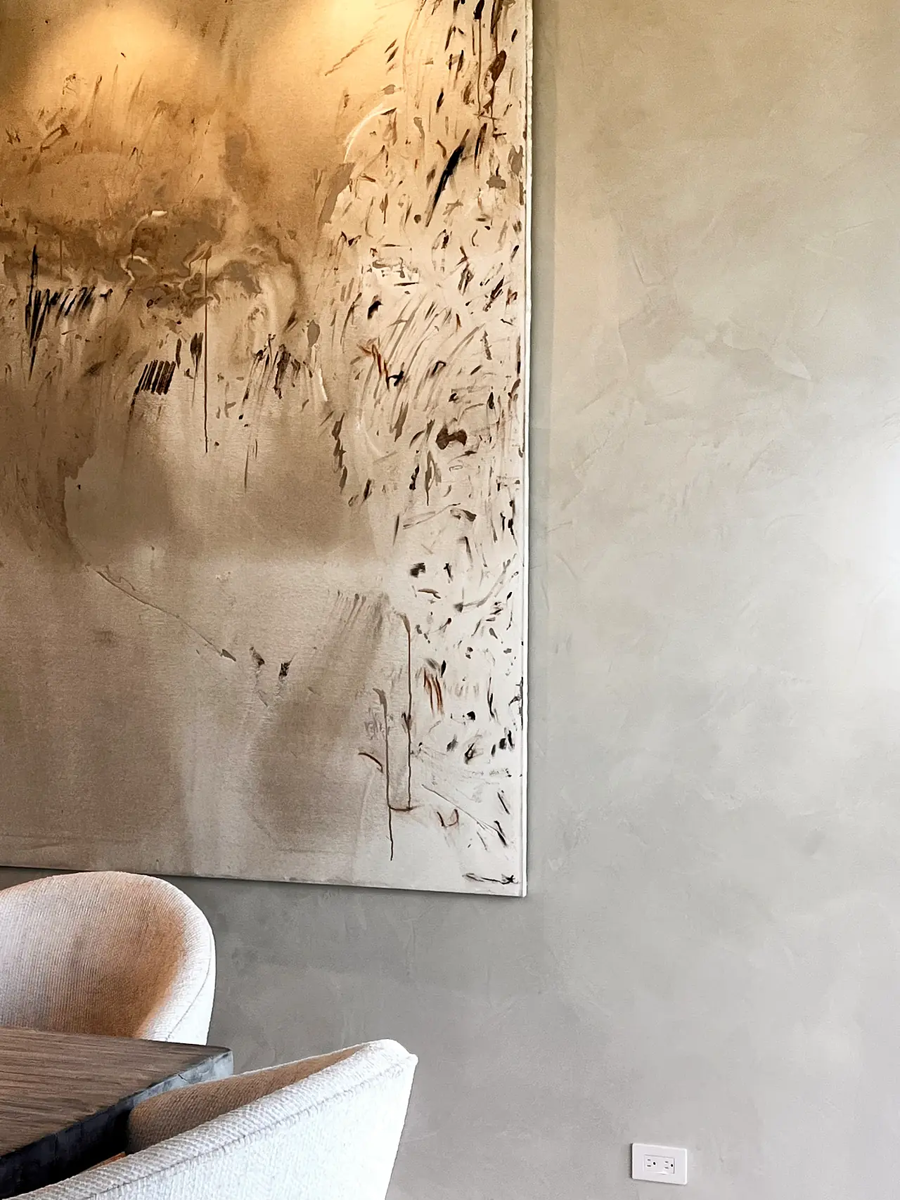 Limewash wall texture beside large abstract artwork in a Los Angeles home