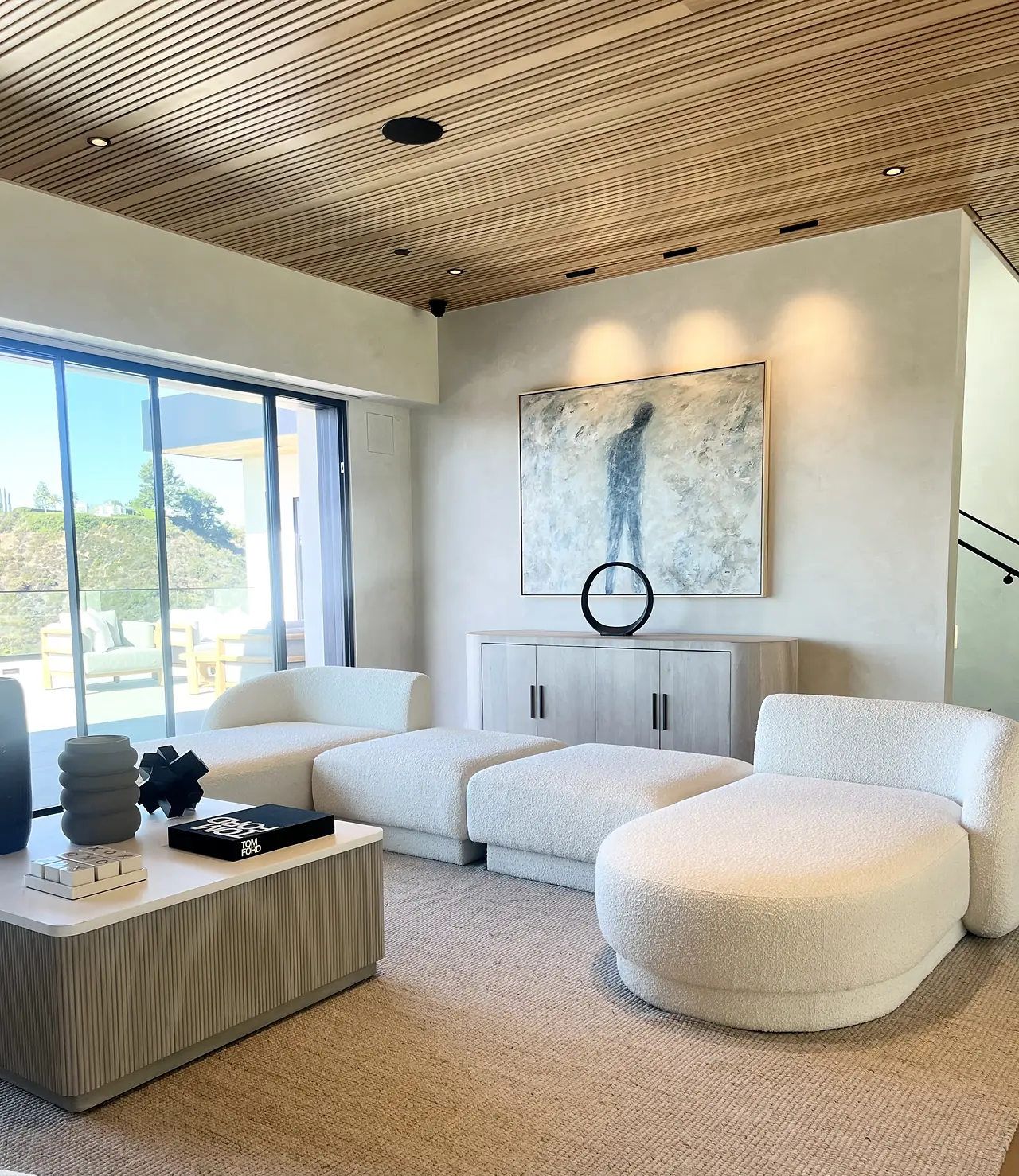 Family room with smooth plaster walls and a curved sectional
